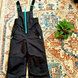 Black and blue snowsuit ski bib
